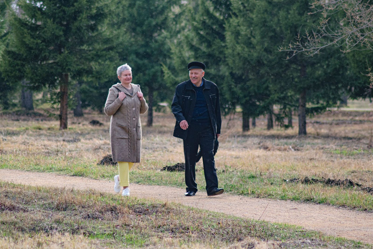 Couple walking along a park path