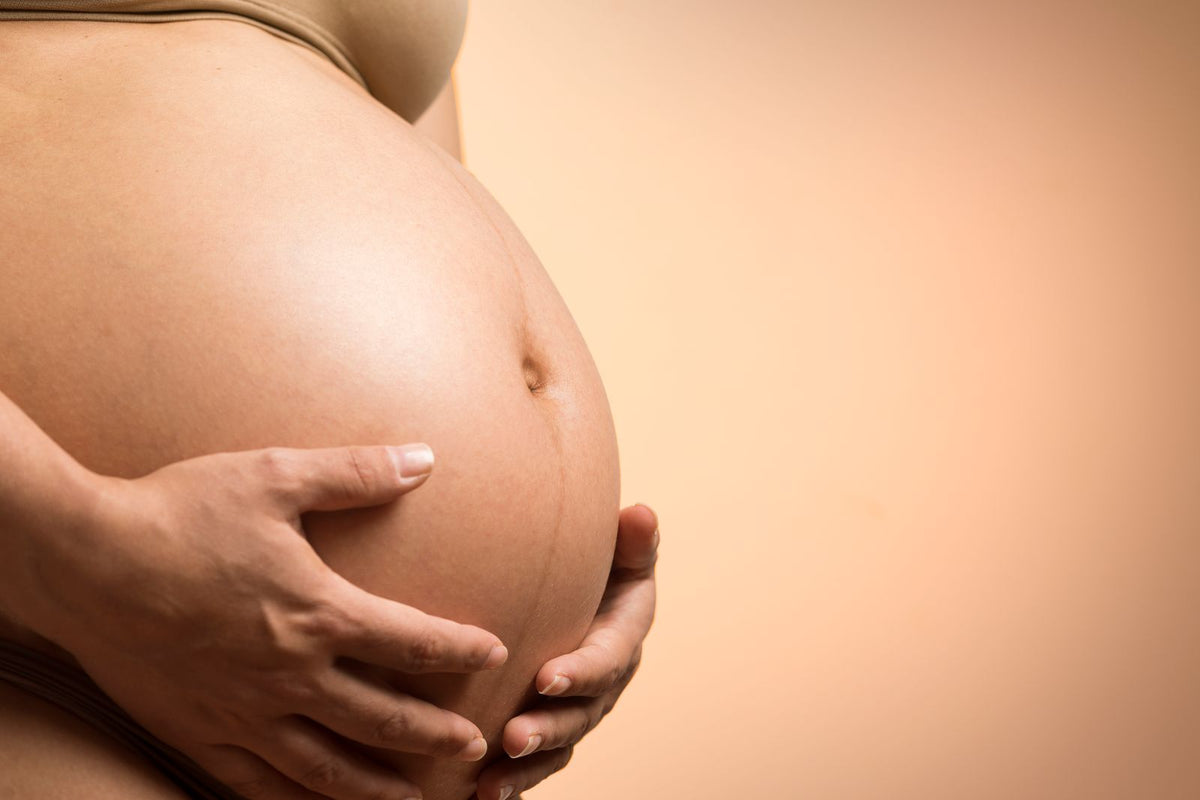 Hands resting on a pregnant belly