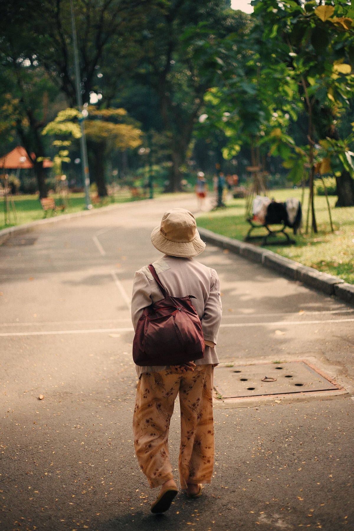 Woman walking through a sunny park