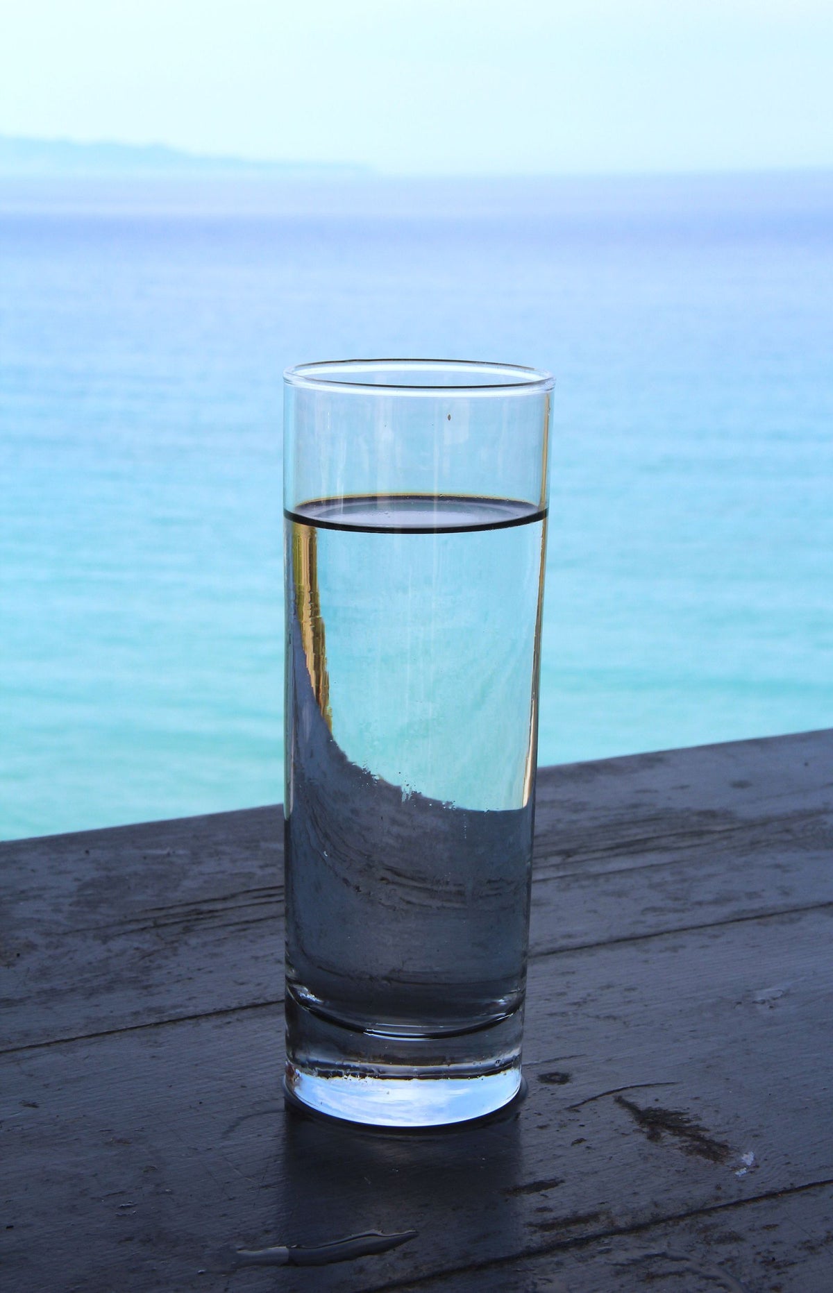 Tall glass of water by the sea