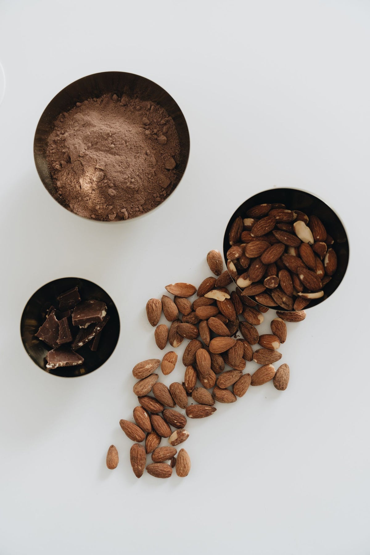 Almonds and dark chocolate with cocoa powder