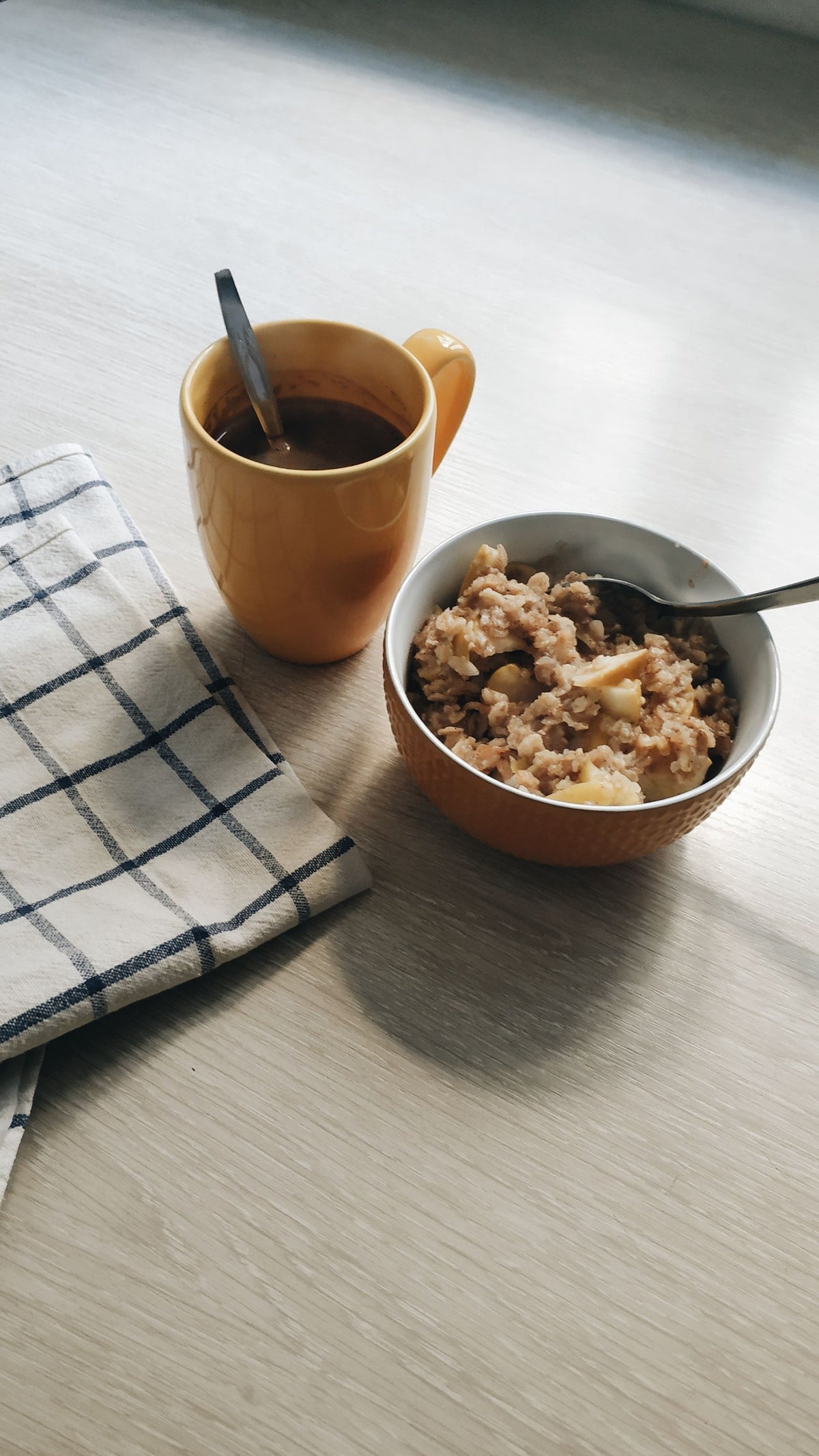 Breakfast of oatmeal and coffee on a wooden table