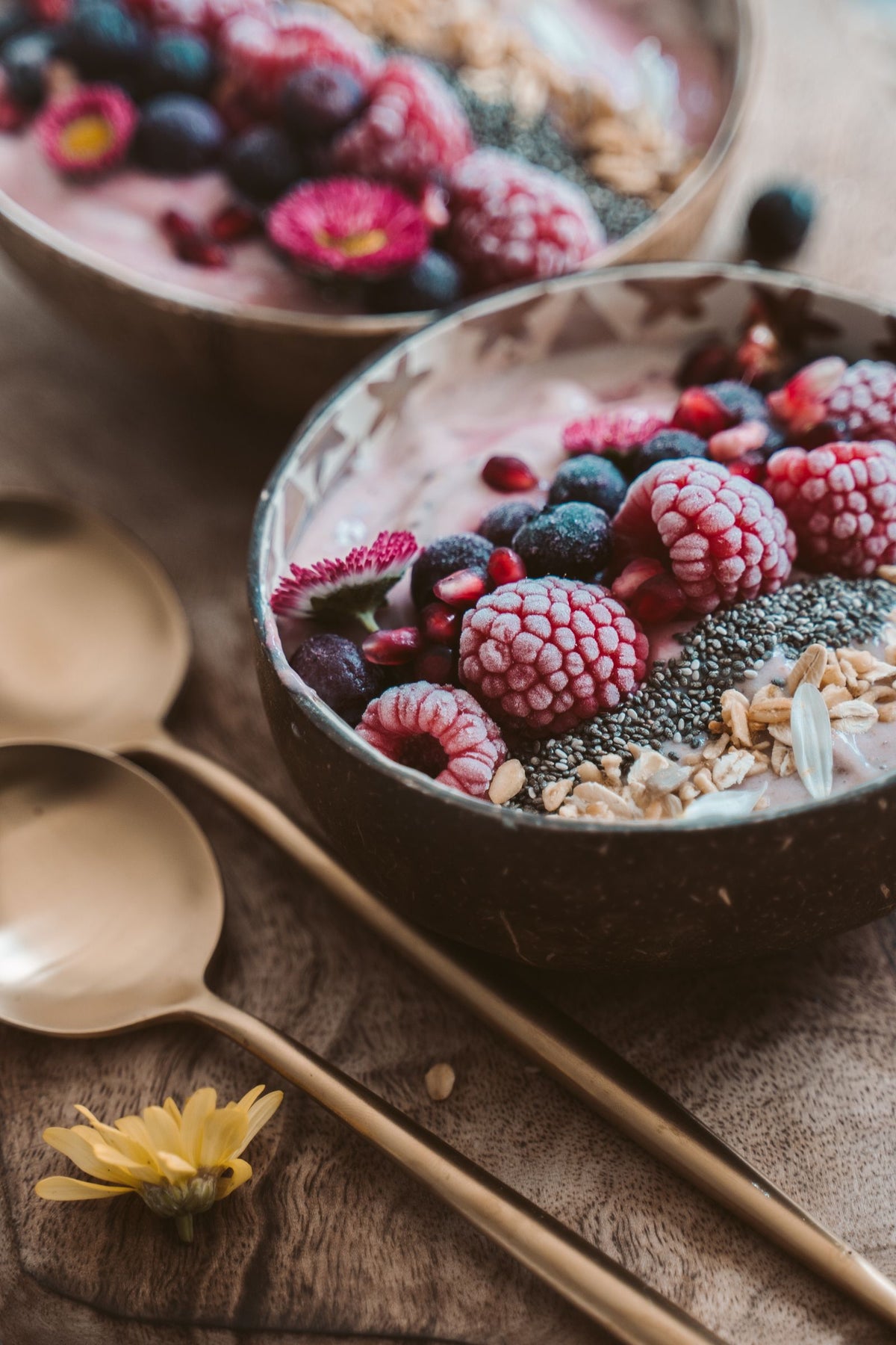 Berry smoothie bowl topped with nuts and seeds