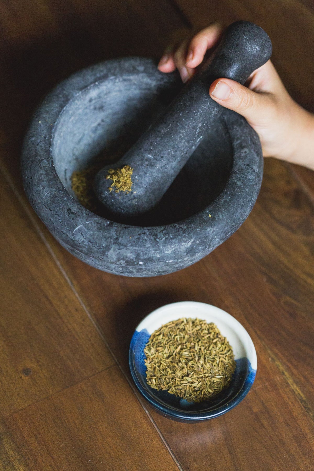 Hand grinding with a mortar and pestle