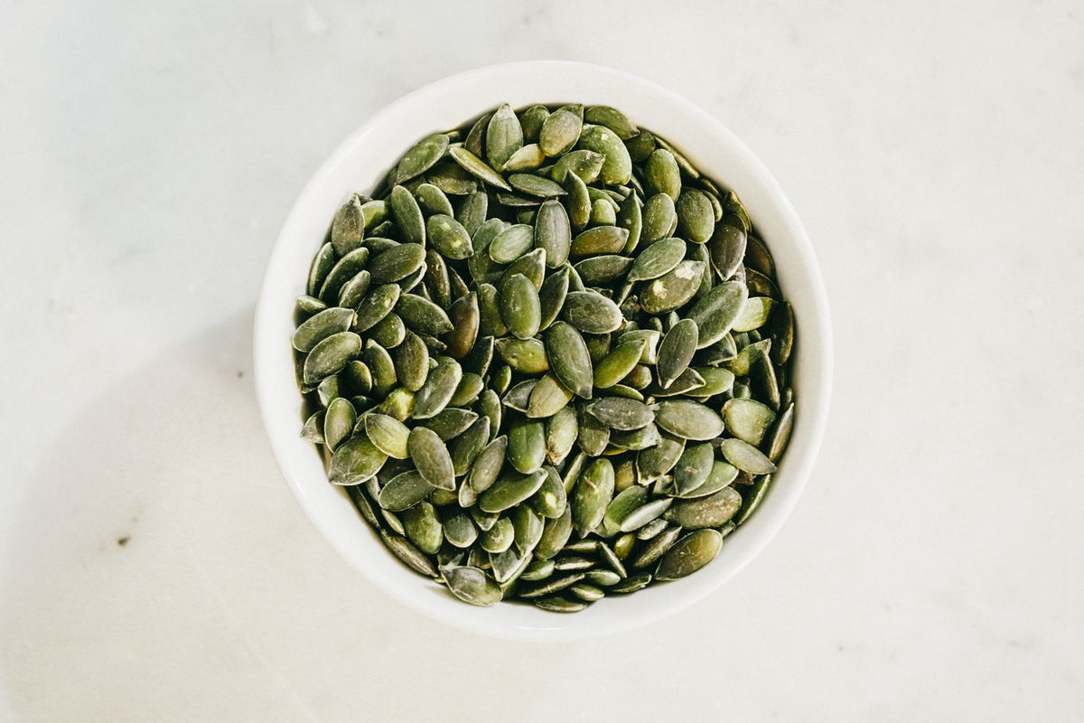 Pumpkin seeds in a white bowl