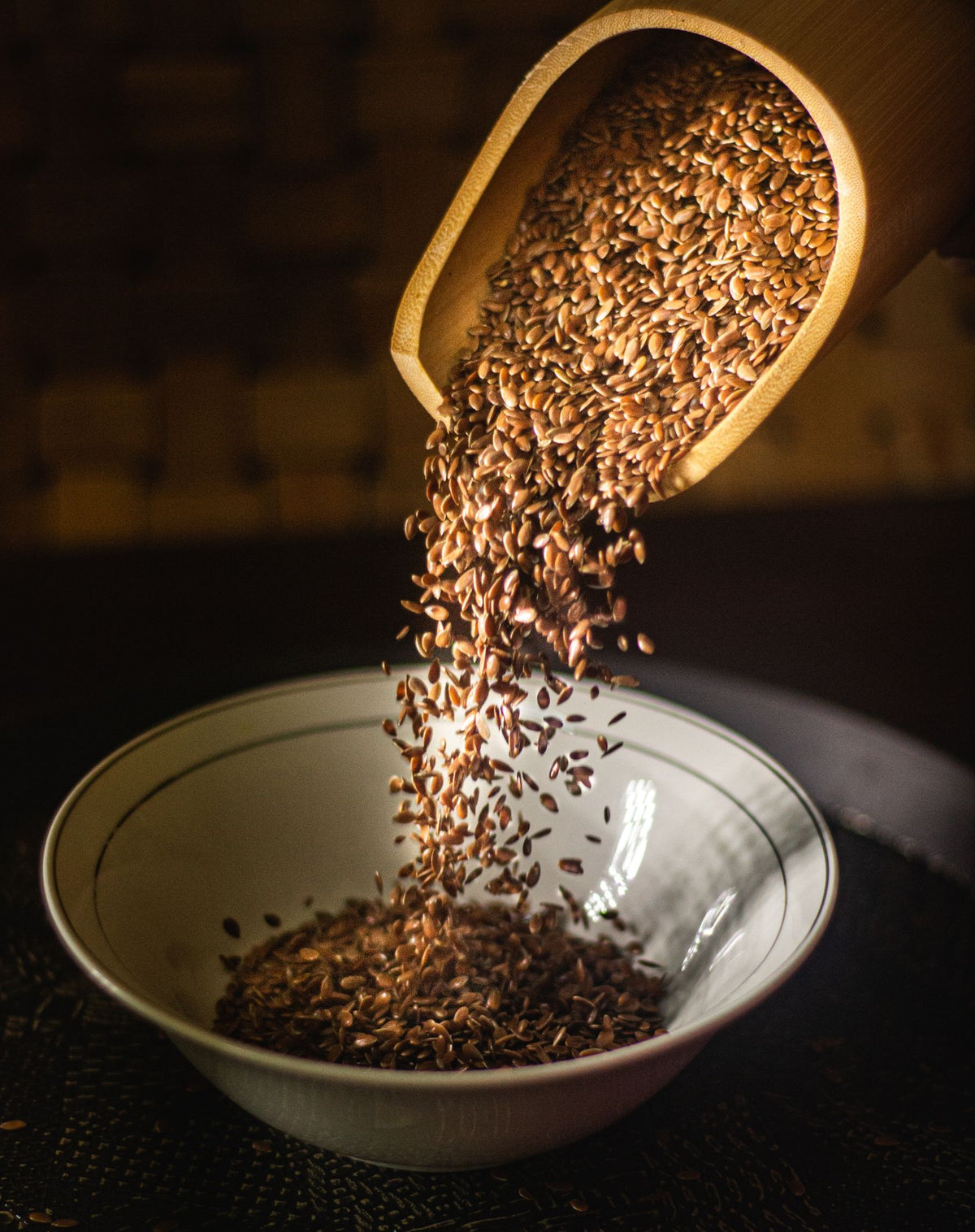 Flax seeds being poured into a bowl