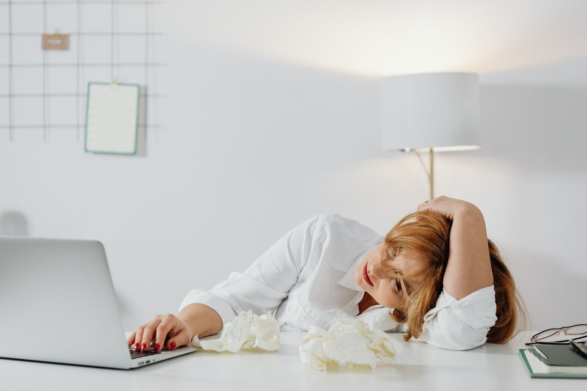 Tired woman resting her head on a desk