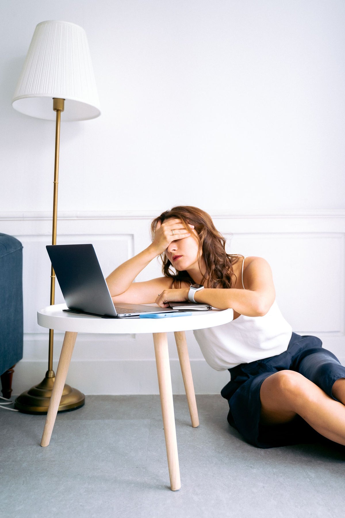 Woman looking tired while working on a laptop