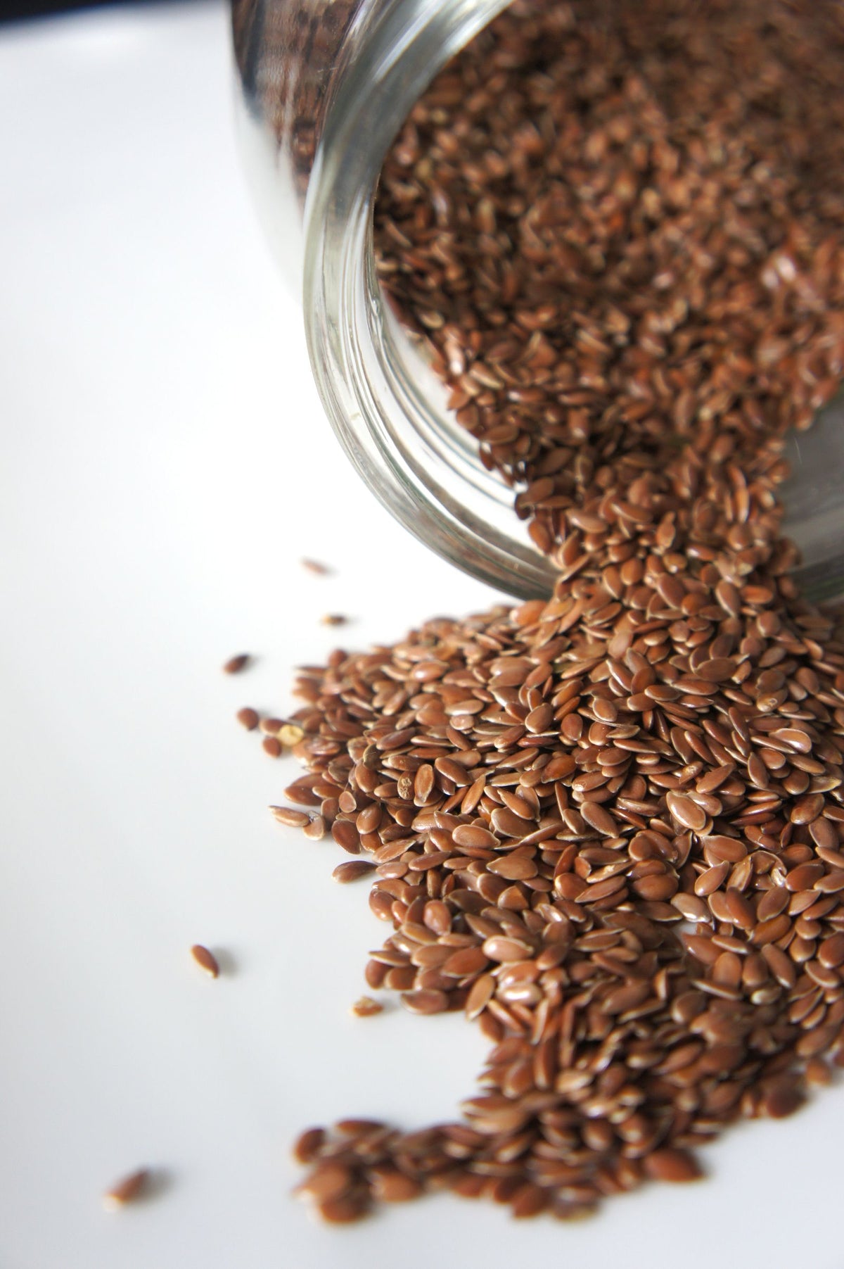 Flaxseeds spilling from a jar