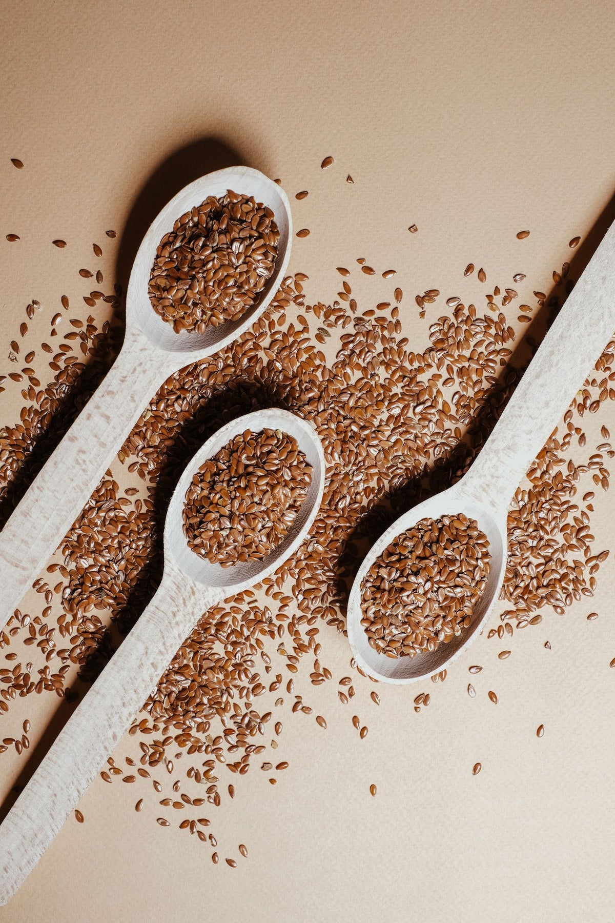 Wooden spoons filled with flaxseeds