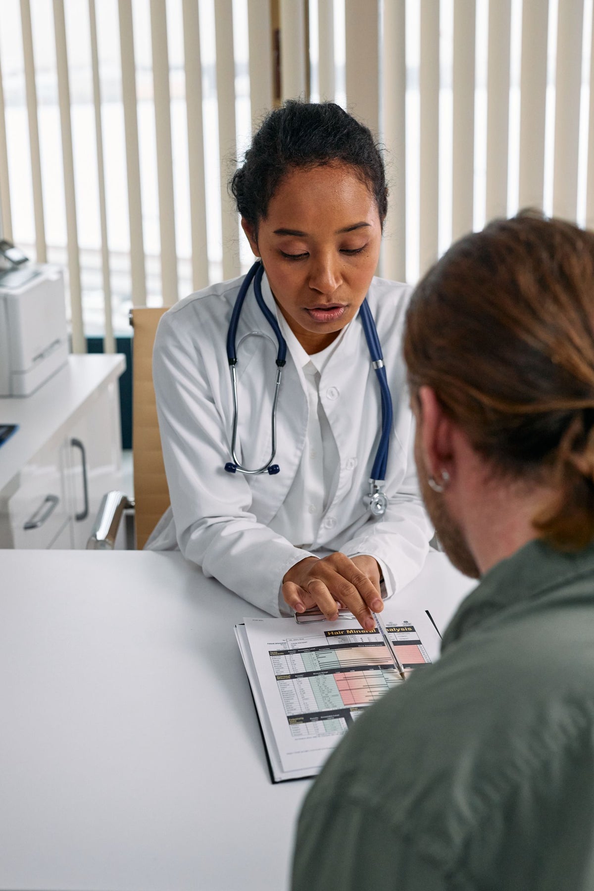 Doctor discussing a health chart with a patient