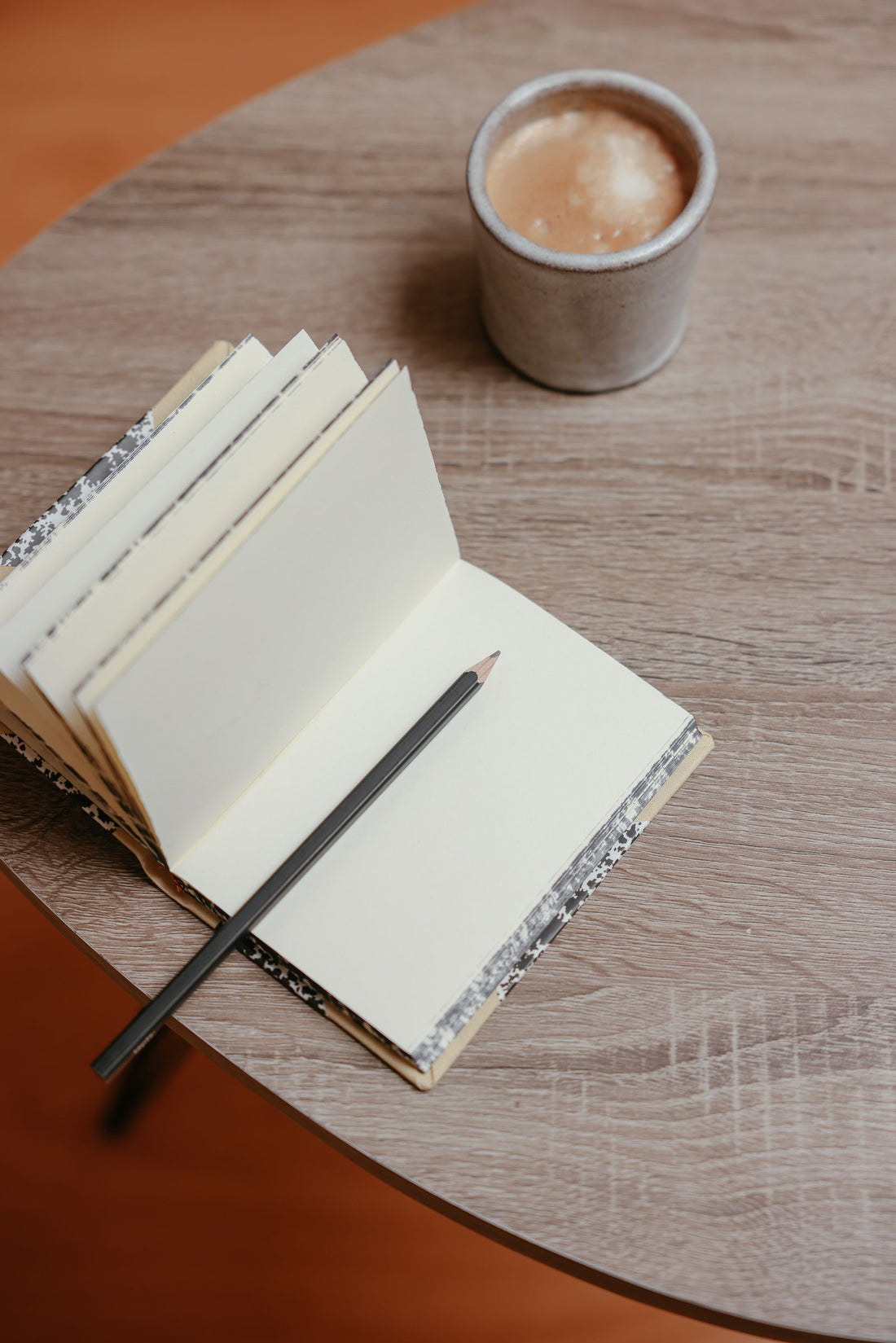 Open notebook and coffee cup