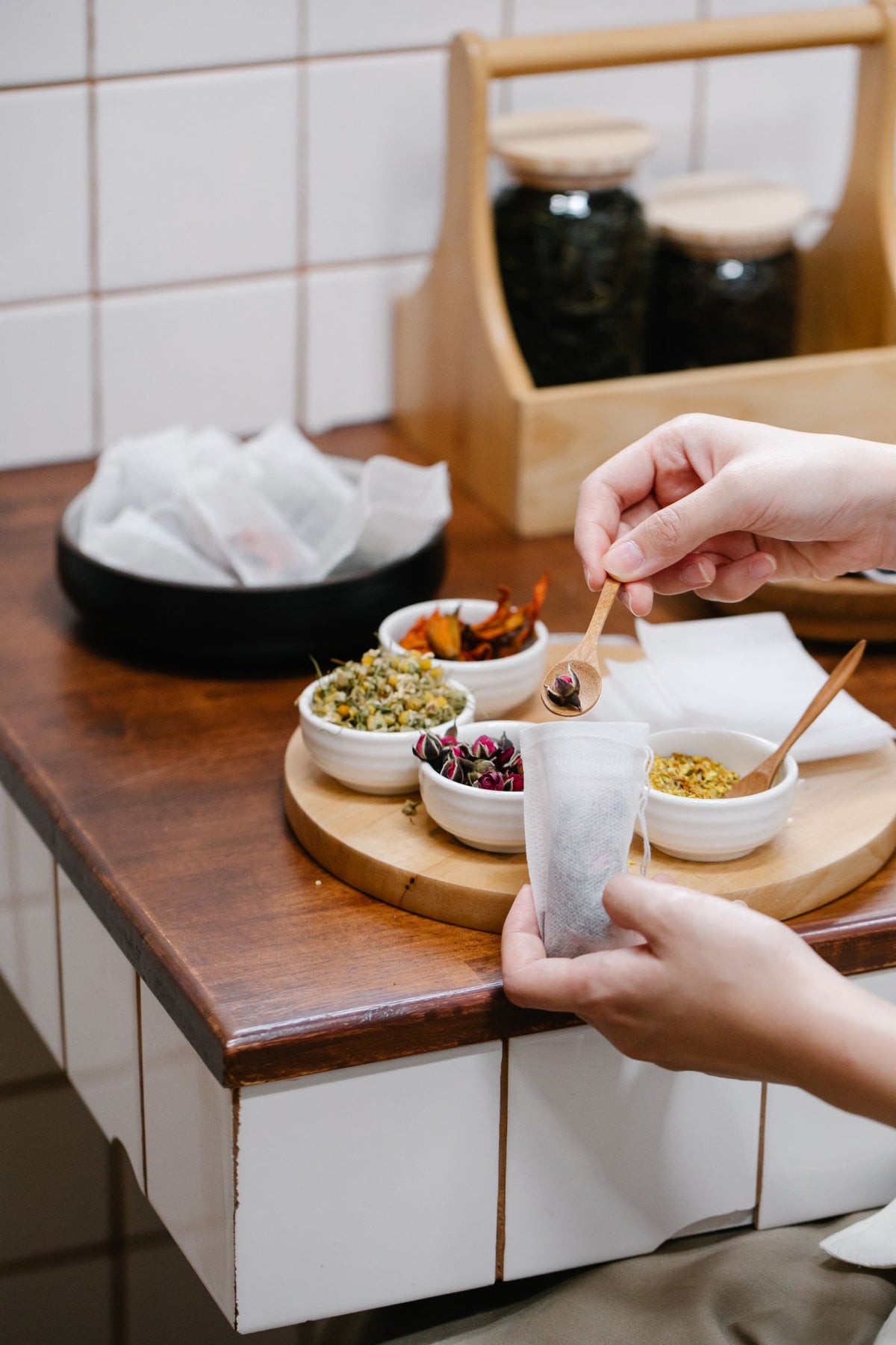 Hands preparing herbal tea