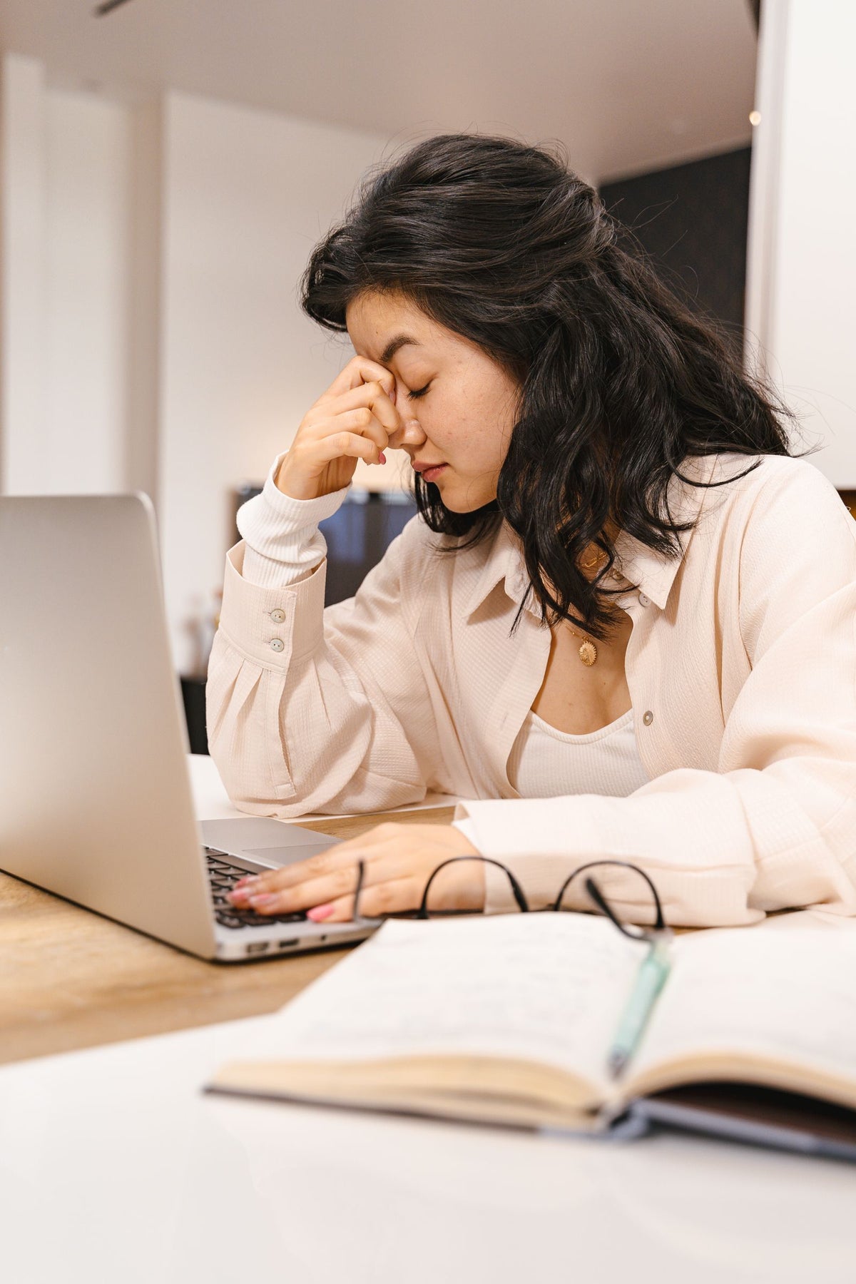 Woman looking frustrated while working on a laptop