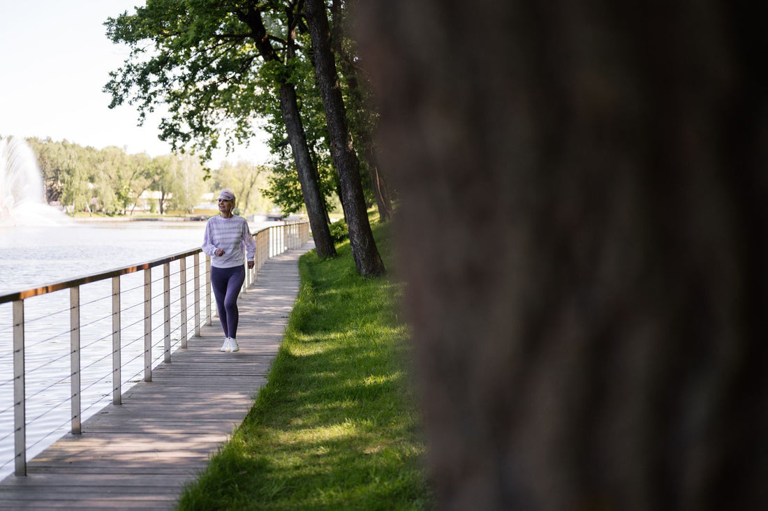 Woman walking on a lakeside boardwalk